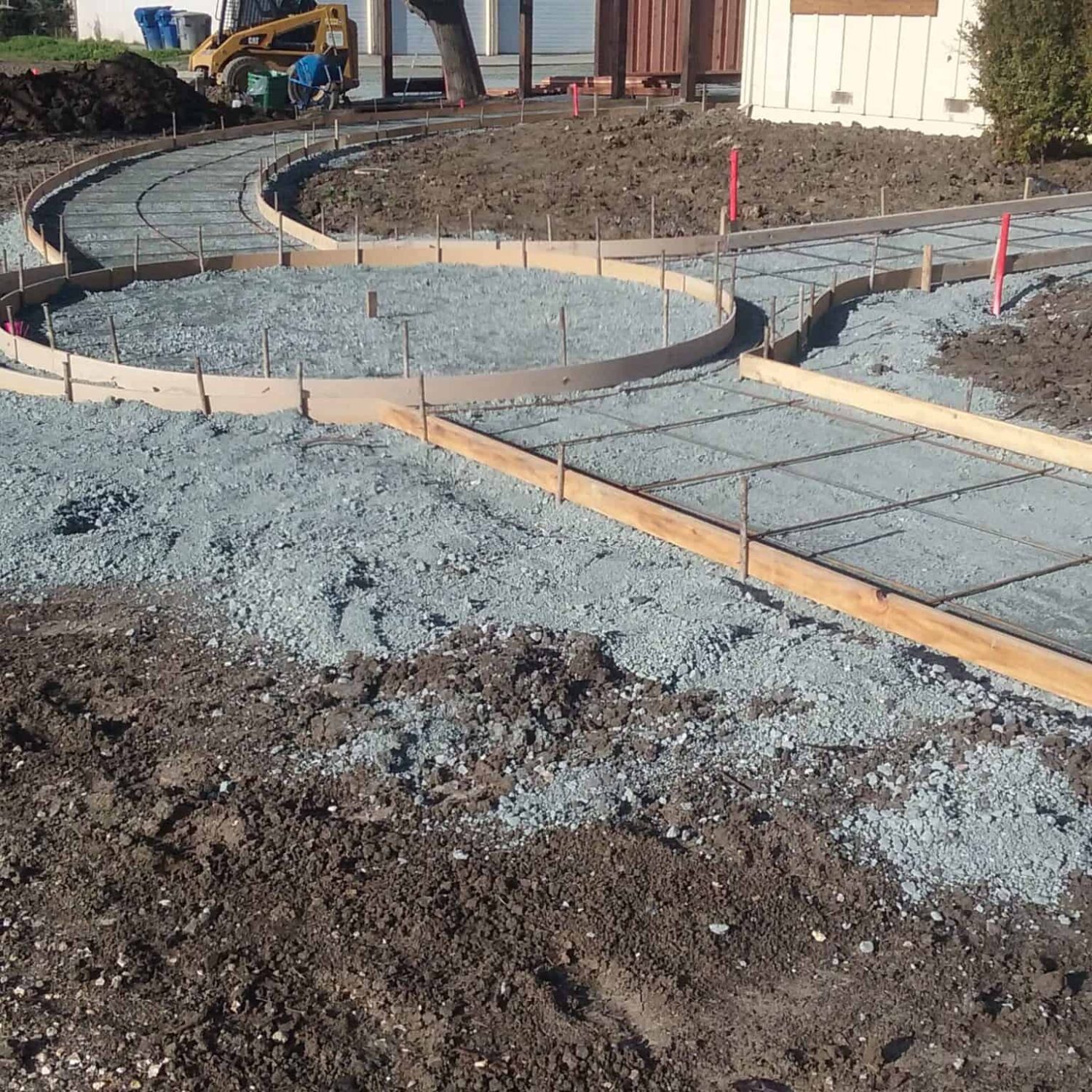 Excavation and grading process for garden pathway, showcasing landscape project.